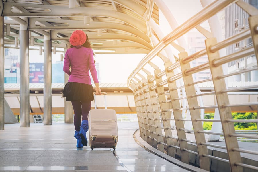 Woman Traveller In Airport Walkway