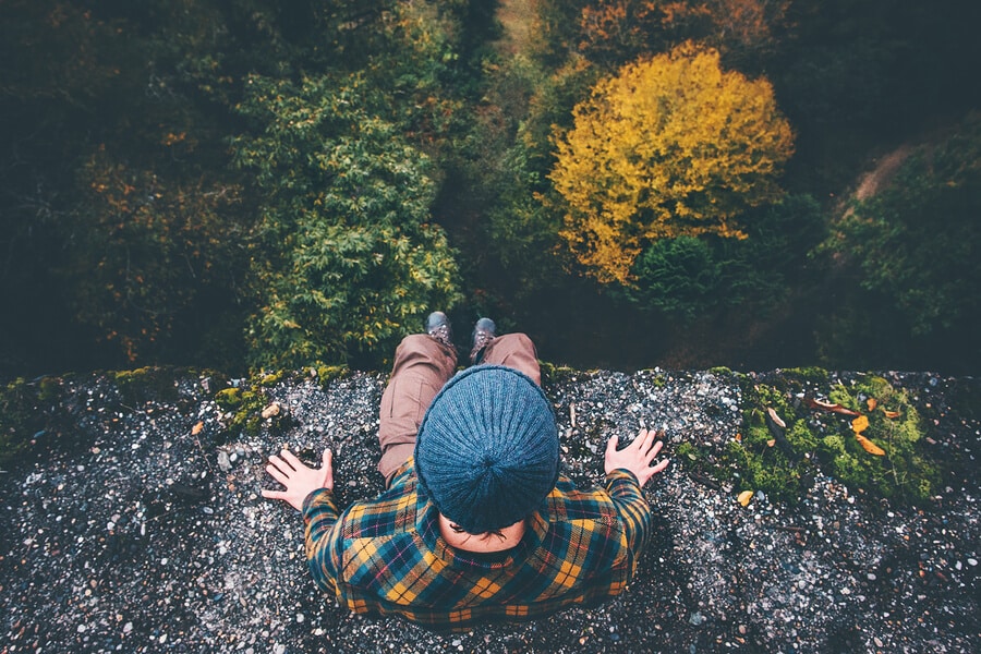man sitting on a cliff