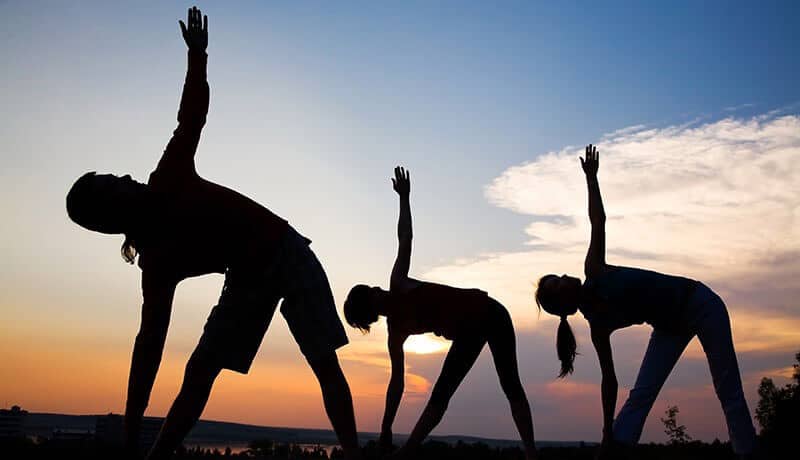 people doing yoga on the outdoor